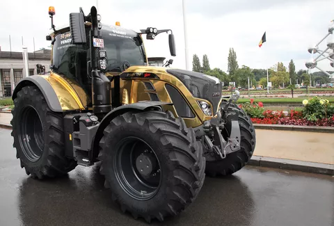 The golden tractor on the street