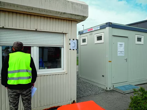 Truck driver at the gate to register