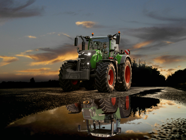 Ein Fendt 700 Vario Gen7 auf der Straße vor dramatischem Sonnenuntergangshimmel