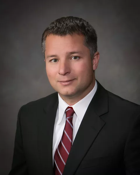 Joe DiPietro (Vice President of Fendt North America) in a suit in front of a grey backround