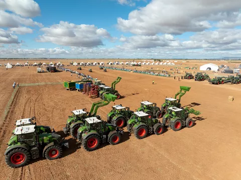 two rows of different Fendt tractors waiting for their presentation at Fendtgüinos 2024, tents in the background