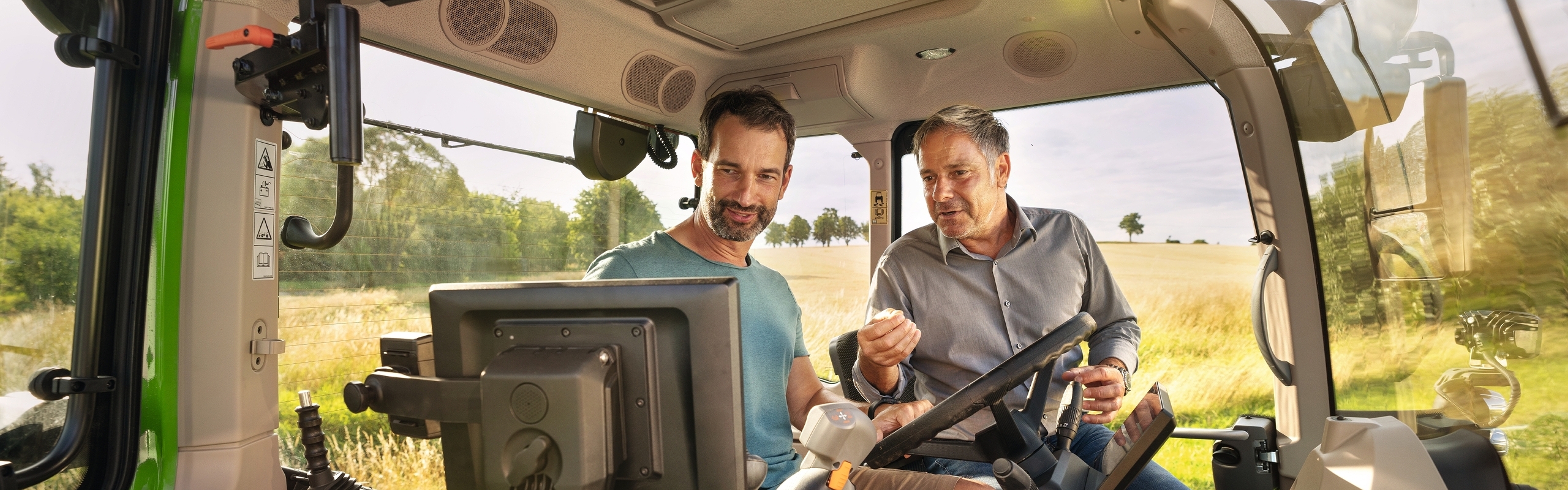 A Fendt dealer introducing a farmer to the new 700 Vario Gen7 with FendtOne Onboard