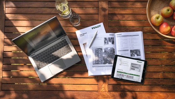 A farmer's desk with catalogues and laptop