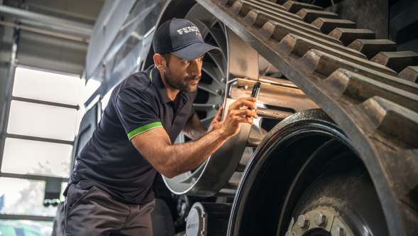 Fendt Service employee checking parts on the Ideal combine harvester