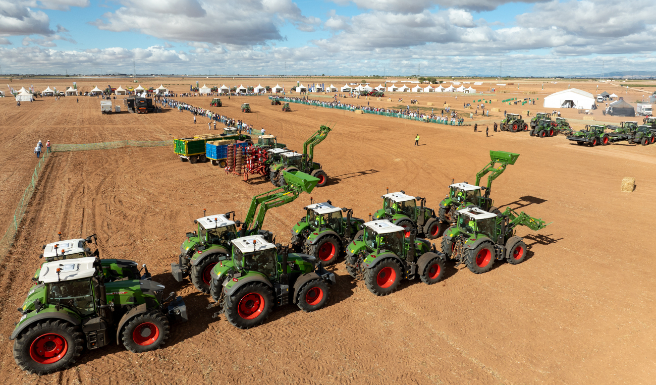 two rows of different Fendt tractors waiting for their presentation at Fendtgüinos 2024, tents in the background