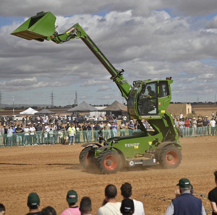 A Fendt Cargo T telehander being presented with its lift cab at the Fendtgüinos 2024,people watching in the front and back of the image