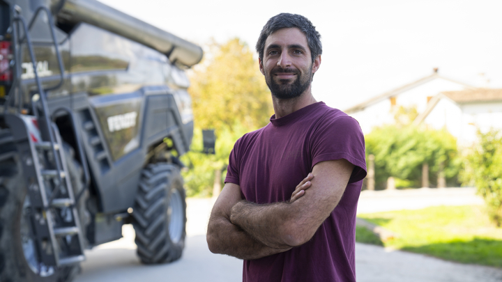 Ivan Tosi standing in front of his Fendt IDEAL combine