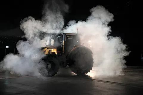 Golden tractor with smoke