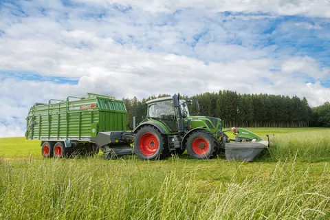 Fendt tractor with mower and loader wagon