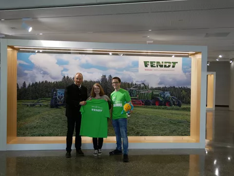 T-shirt handover between two men and a girl