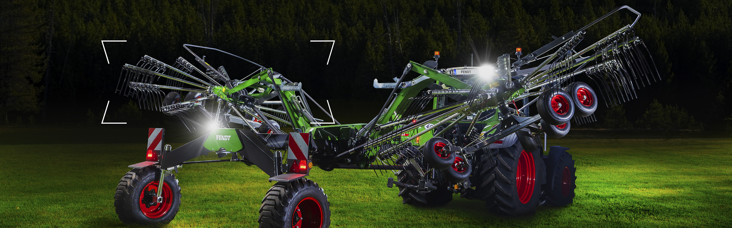 A Fendt Former stands on a green meadow at dusk and is staged with light.