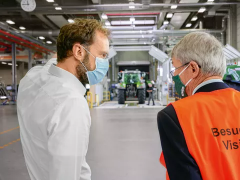 ltr. Peter Bebersdorf (Director, Manufacturing Tractors Marktoberdorf) and Wolfgang Kirsch in conversation at the light tunnel at the end of tractor assembly line