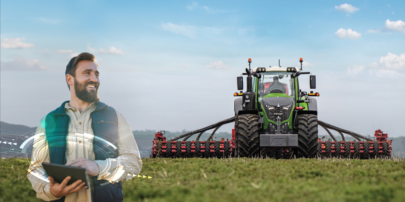 Farmer with iPad and Fendt tractor in the field