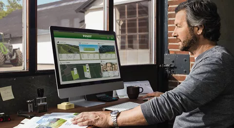 Farmer sits in front of the PC